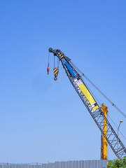 Blue construction crane on bule sky background