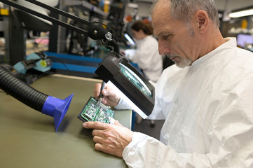 Engineer working in lab on microeletronics system
