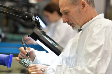 Engineer working in lab on microeletronics system