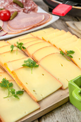 fromage à raclette et charcuterie sur une table