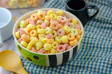 Cereal flakes in bowl with copy space,Breakfast concept.Food with delicious fruity taste and fruity colours.It's made with maize,wheat,and barley