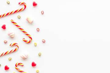 Christmas candies frame on white backgound top-down copy space