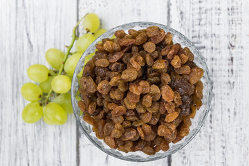 Portion of fresh Raisins on an old wooden table