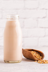 A bottle of buckwheat milk and raw buckwheat.
