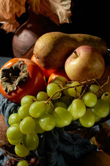 Basket of ripe fruits on the table.
