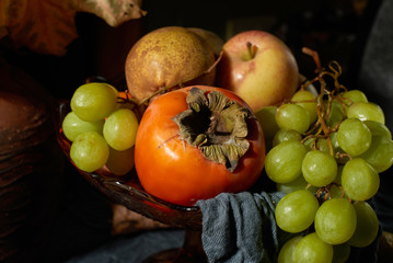 Basket of ripe fruits on the table.