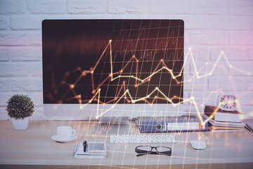 Forex graph hologram on table with computer background. Double exposure. Concept of financial...