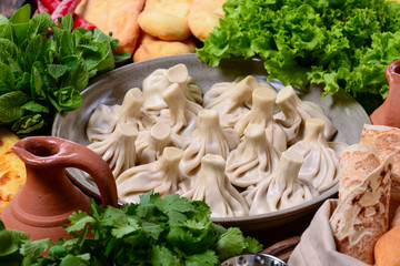 Top view of traditional Georgian cuisine: Kolkh and Adjara khachapuri, khinkali dumplings, shotis puri, kubdari or kubed