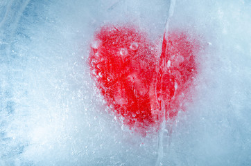 A red heart frozen in ice with a deep crack, a symbol of love or betrayal or separation