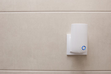 Wifi home repeater plugged in closeup.