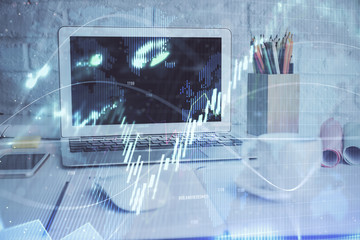 Stock market graph and table with computer background. Double exposure. Concept of financial analysis.
