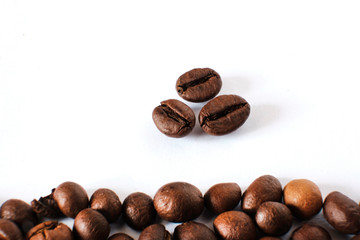 Coffee beans lie on a white sheet of paper