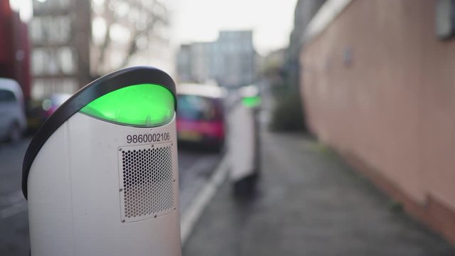 Electric charging points or stations with green light on the streets of London