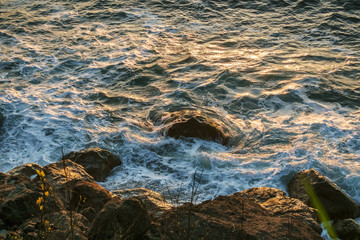 Stormy sea waves crashing against a rocky shore