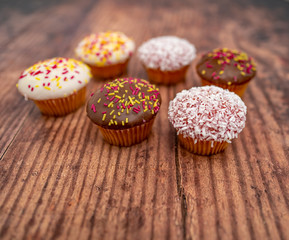 Top down view of selective focus on a chocolate cupcake on a wooden background