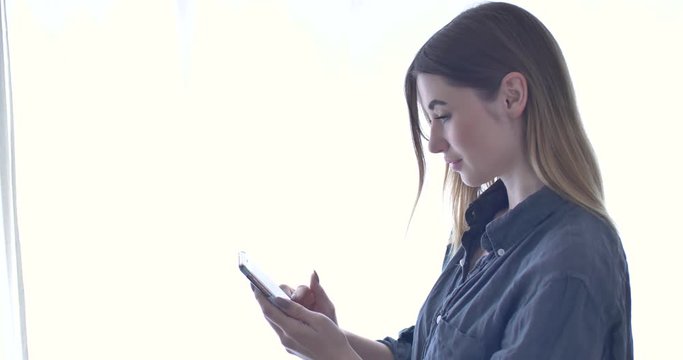 Attractive Young Adult Influencer Woman Typing on Smartphone