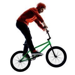 Naklejka premium one young caucasian man BMX rider cyclist cycling freestyle acrobatic stunt in studio isolated on white background