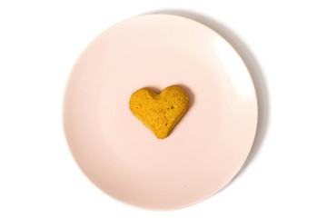 pink plate with heart-shaped cookie isolated on white background