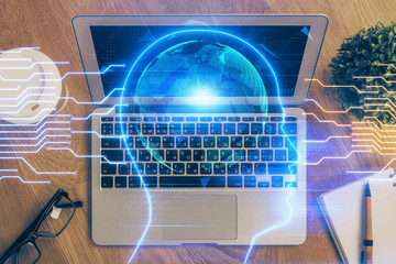 Multi exposure of work table with computer and brain hologram. Brainstorm concept.