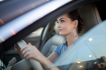 Obraz na płótnie Canvas Pretty, young woman driving a car -Invitation to travel. Car rental or vacation.