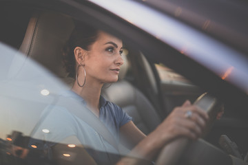 Pretty, young woman  driving a car -Invitation to travel. Car rental or vacation.