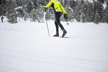 Cross-country skiing: young man cross-country skiing on a winter day