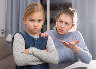 Serious mother scolding her daughter