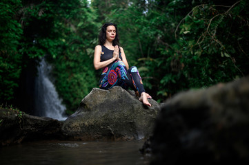 Fototapeta na wymiar Yoga practice and meditation in nature. Woman practicing near river
