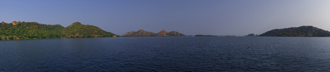 Fototapeta premium Beautiful Panoramic view of mountains surrounded by water - boat ride