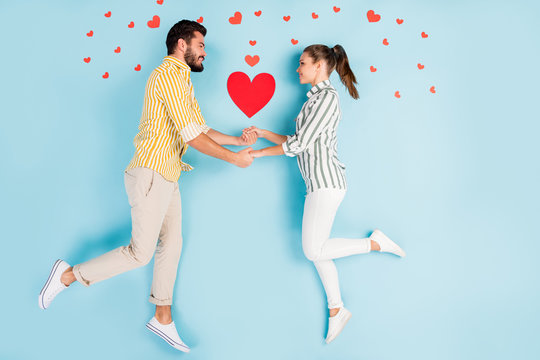 Top view above high angle flat lay flatlay lie concept full length body size view of nice sweet couple holding hands isolated on bright vivid shine vibrant blue turquoise color background
