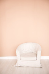 White chair in the interior on a pink background. Copy space