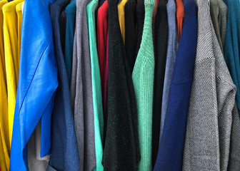 sweaters of different colors hanging