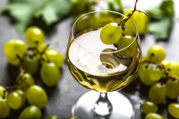 White wine glass and fresh grapes