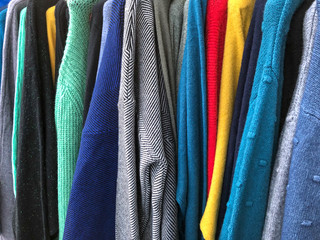 sweaters of different colors hanging