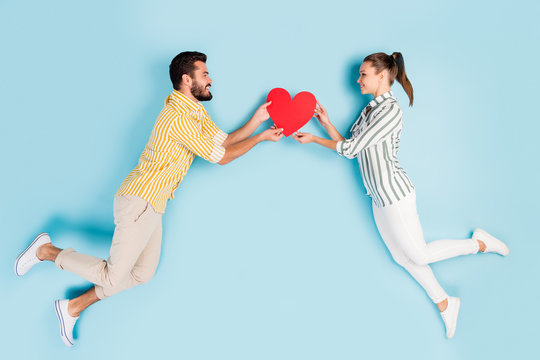 Top view above high angle flat lay flatlay lie concept full length body size view of nice couple flying holding heart isolated on bright vivid shine vibrant blue turquoise color background