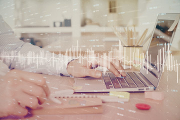 Multi exposure of stock market graph with man working on laptop on background. Concept of financial analysis.