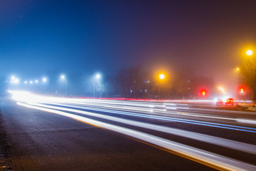 Road at night with light lines from headlights