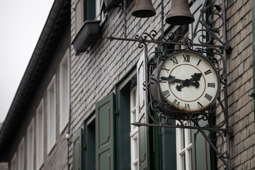 Fototapeta na wymiar Antique clock on side of european building in monschau germany