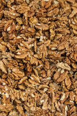 Closeup of big shelled walnuts pile. Selective focus.