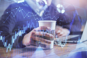 Forex graph with businessman working on computer in office on background. Concept of hardworking. Closeup. Multi exposure.