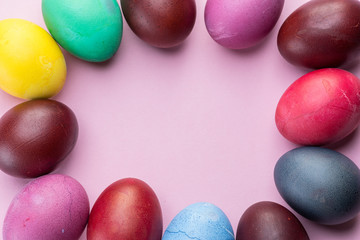 Colorful Easter eggs as an attribute of Easter celebration. Pink background.