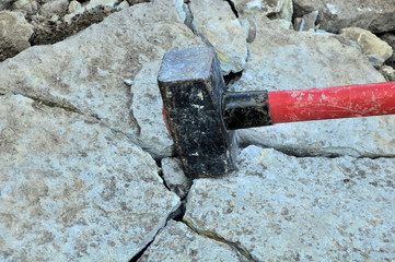 big iron hammer smashes stone