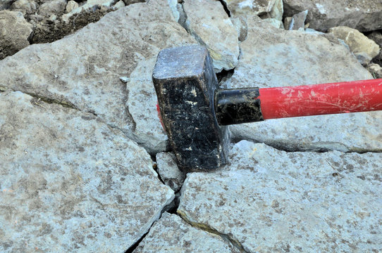 big iron hammer smashes stone