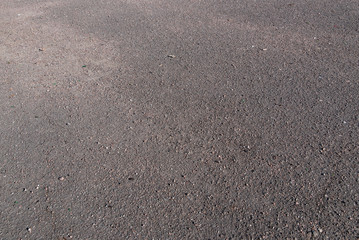 Texture: gray asphalt in sprinkled asphalt chips, small stones and other debris