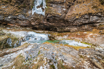 Winter. Ice games in the Fontanon of Goriuda waterfall. Friuli, Italy.
