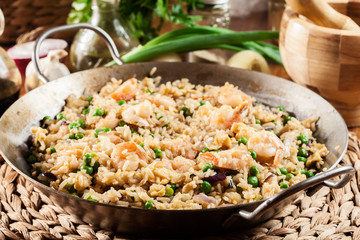 Fried rice with shrimp and vegetables on a frying pan