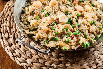 Fried rice with shrimp and vegetables on a frying pan