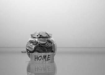 Money jar with coins  Saving for House Concept