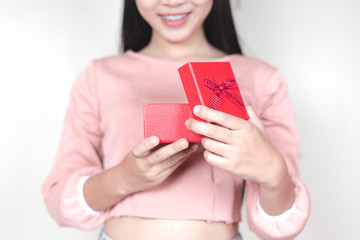 A close up of a woman holding a gift box.