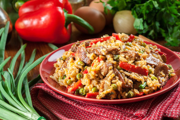 Fried rice with chicken and vegetables served on a plate